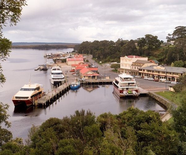 Boats moored at a harbour in a small town